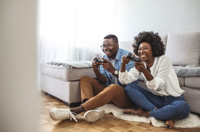 Capture Couple plays video games at home.Valentine's Date Tips!