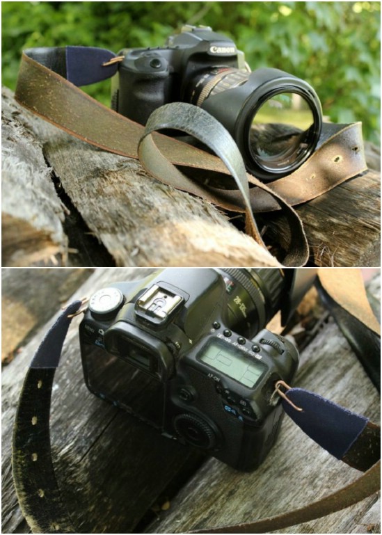 A camera sits on a log with a leather strap made from an old belt.